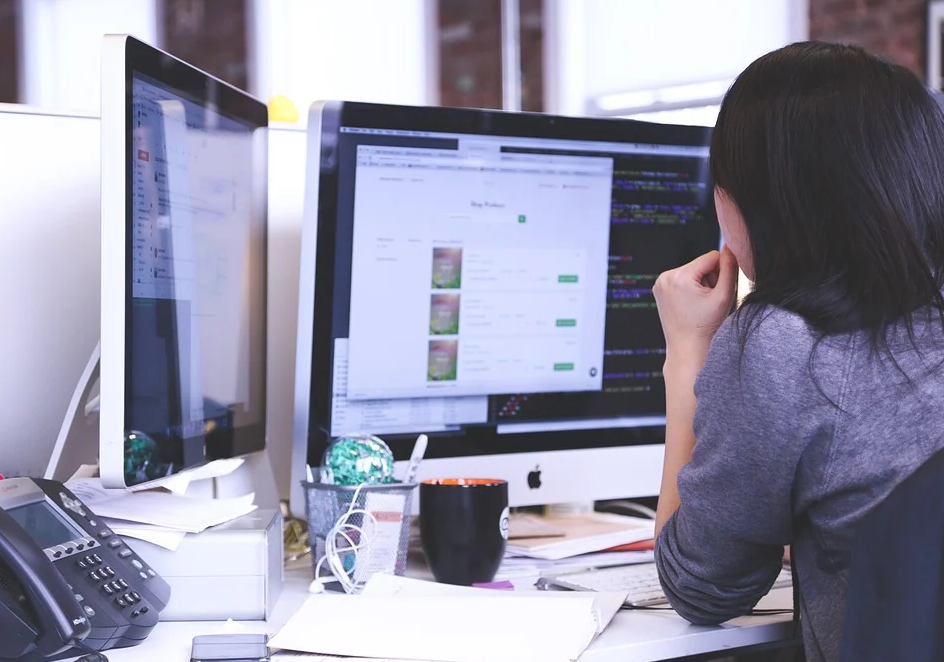 woman behind computer monitor